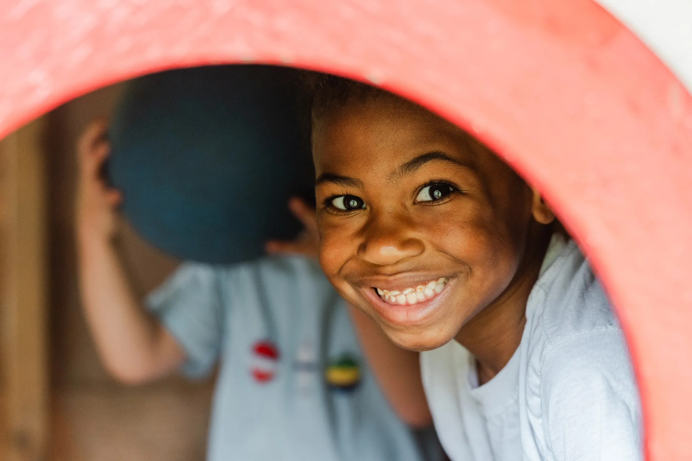A smiling child playing outdoors