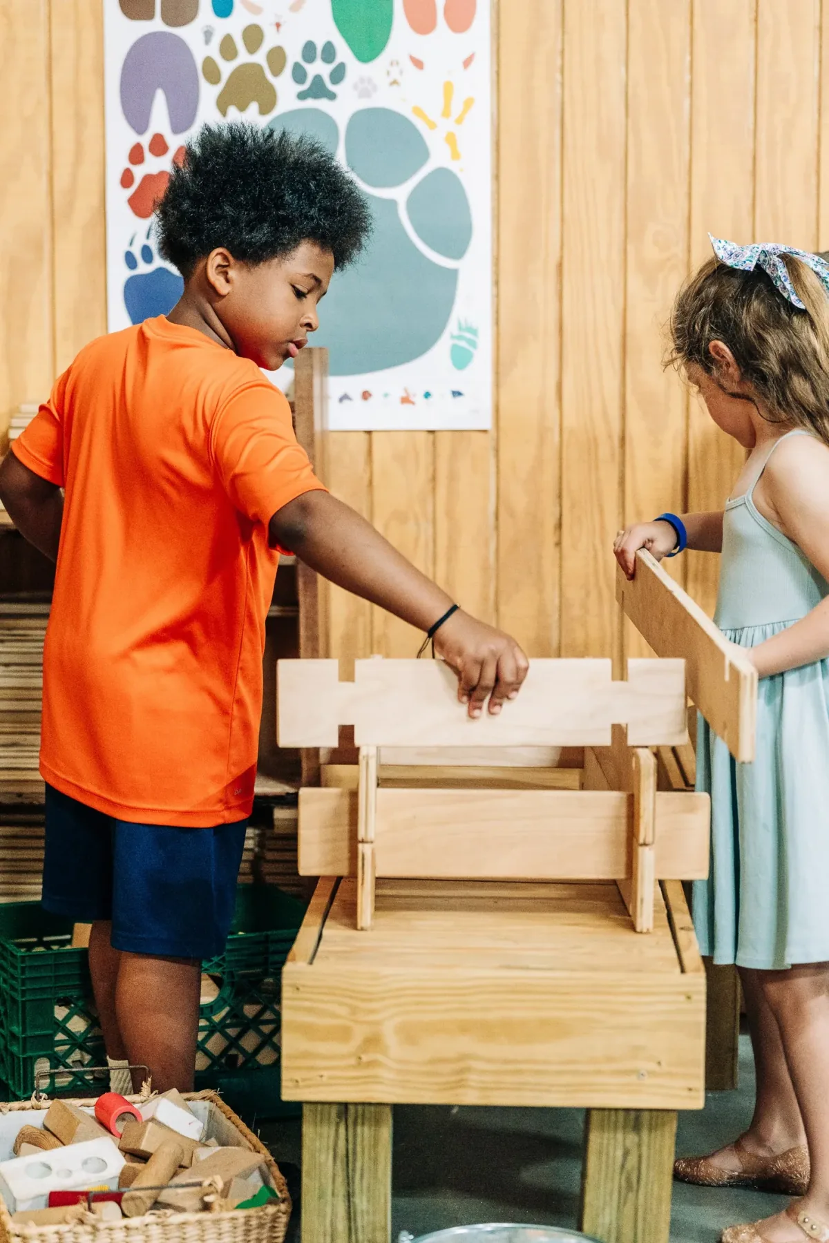 Children building together with wooden materials